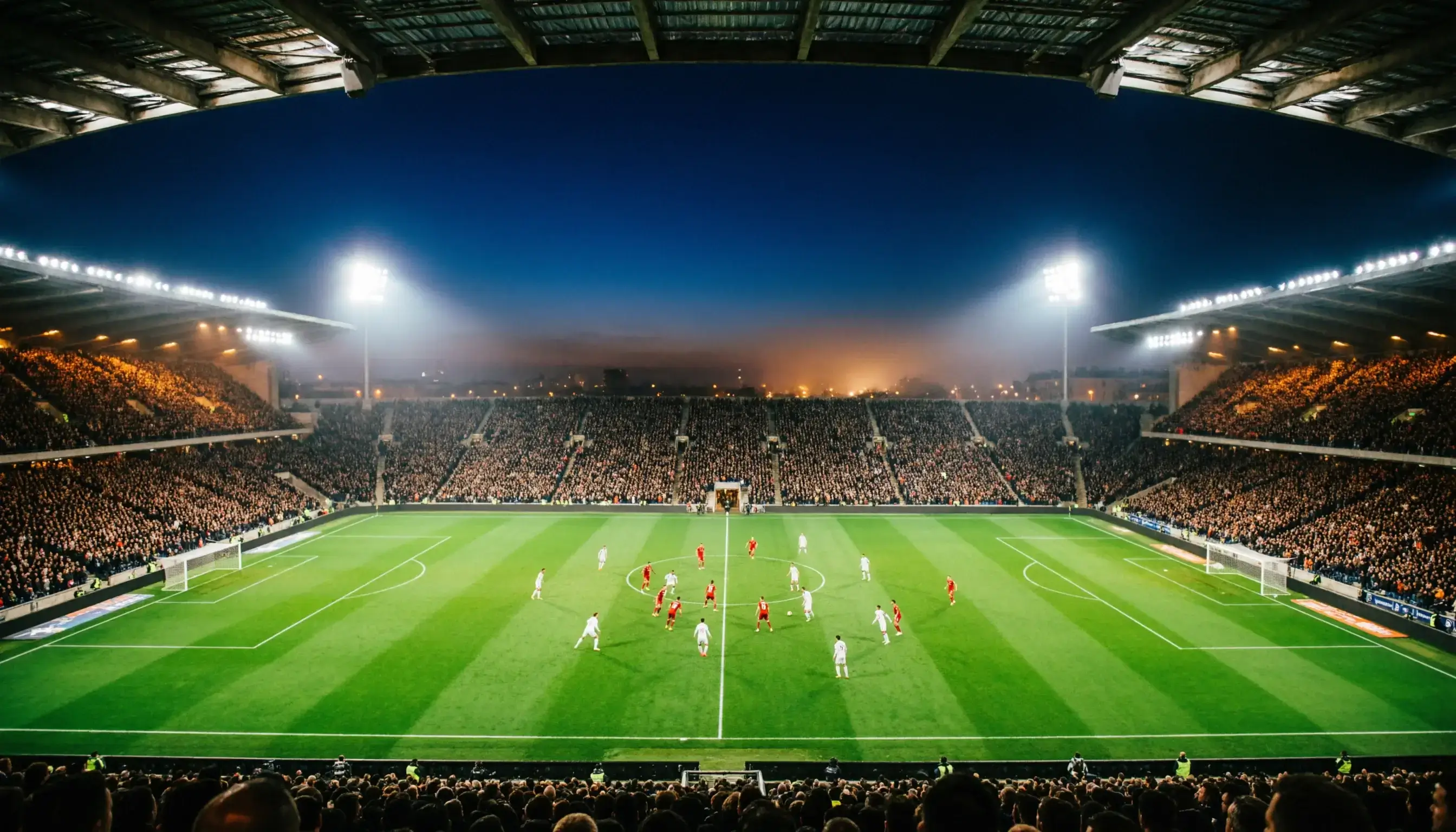 Voetbalstadion tijdens een avondwedstrijd in de Eredivisie met verlichte tribunes